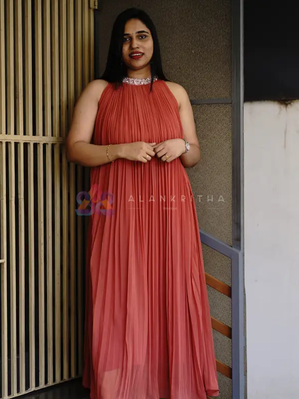 Coral Glow: Pleated Gown
